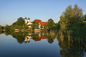 Romanesque Benedictine Abbey Seeon Monastery, monastery church St. Lambert with reflection in the