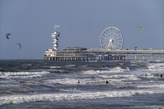 View over the beach of Scheveningen, the pier with Ferris wheel belongs to the city of The Hague