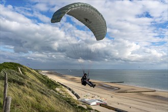 Paragliders along the dunes of Zoutelande, in Zeeland, South Holland, Netherlands