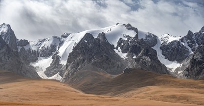 Dramatic mountain landscape with yellow meadows, mountain peaks, Keltan Mountains, Sary Beles