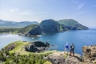 Aerial view, drone photo: Two men standing on a cliff above Bottle Cove, Bottle Cove Provincial