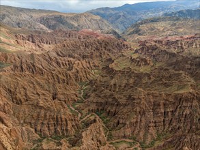 Eroded mountain landscape, canyon with red and orange rock formations, aerial view, Konorchek