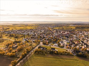 Aerial view of a small town in autumn, surrounded by fields and colourful trees, Jettingen, Black