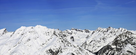 Alpine panorama with snow-covered mountain peaks in winter. Taken in the ski resort of Serfaus Fiss