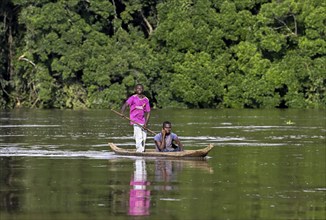 Two young men in a dugout canoe on the Sangha River, Dzanga-Sangha Complex of Protected Areas