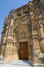 Impressive Gothic church façade with ornately carved portal and massive stone doors, Basilica Santa