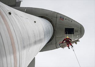 Height rescuers from the Oberhausen professional fire brigade practise abseiling from a wind