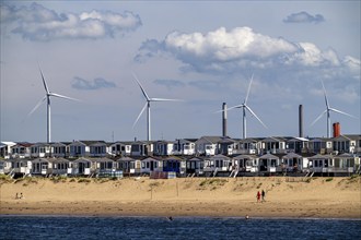 Wind turbines, wind farm, holiday homes, beach houses on the beach of Ijmuiden in North Holland,