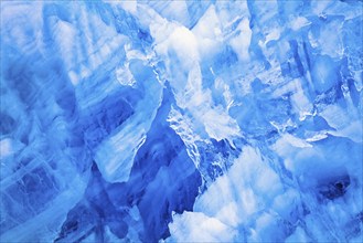 Abstract natural ice pattern on a glacier with blue colored ice, Svalbard