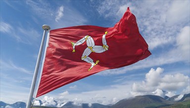 The flag of the Isle of Man, Great Britain, flutters in the wind