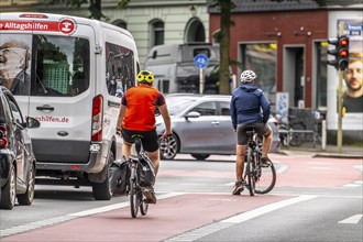 Bicycle lane, marked red, between 2 lanes for vehicles, city centre traffic, Dortmund, North