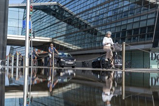 Cyclists on the cycle path on Christians Brygge Street, at the Black Diamond, Danish Royal Library,