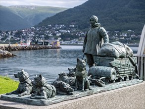 Sculpture of a polar explorer with dog sled, outside museum Polaria, Tromsø, Norway, Europe