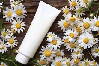 Tube of facial cream surrounded by chamomile flowers. KI generiert, generiert, AI generated