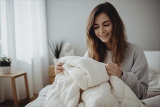 Young woman holding warm duvet bed quilt. KI generiert, generiert, AI generated