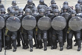 Demonstration of riot squad forming a protective barrier with riot shields during open day of the