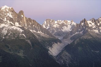 Evening mood with pink evening sky, mountain landscape at sunset, mountain peak Grandes Jorasses