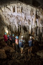 Visitors in a stalactite cave, tourists looking at stalactites in the Terciopelo Cave, Barra Honda