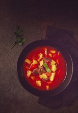 Meat goulash, with potatoes and carrots, sweet pepper, traditional Hungarian soup, homemade, no