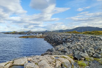 Bridge connecting rocky shores under a cloudy sky, autumn, Atlantic Road, Atlanterhavsveien,