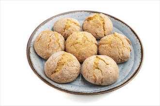 Almond cookies on blue plate isolated on white background. Side view, close up