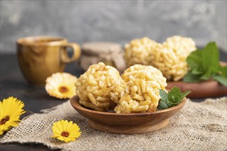 Traditional Tatar candy chak-chak made of dough and honey with cup of coffee on a black concrete