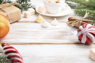 Christmas or New Year composition. Decorations, box, balls, cinnamon, fir and spruce branches, cup