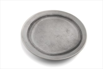 Empty gray ceramic plate isolated on white background. Side view, close up