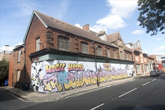 Painted hoarding boards around derelict shop buildings in Upper Orwell Street, Ipswich, Suffolk,