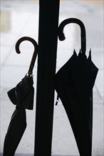 Silhouette of two umbrellas. Berlin, 09.02.2024. Standing in the rain