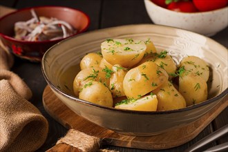 Fresh Cooked, new potatoes, with dill, on a wooden table, selective focus. close-up, toning, no