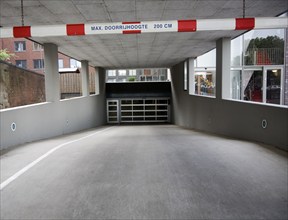 Entrance to parking area of apartments witj height limit restriction barrier Dordrecht, Netherlands