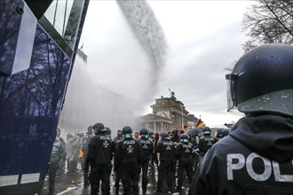 Water cannon in use at the Brandenburg Gate. Once again, thousands of corona deniers are