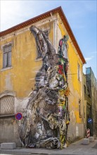 Half Rabbit, a piece of street art by Bordalo II in Vila Nova de Gaia, Porto, is a giant sculpture