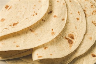 A stack of Mexican tortillas, on a gray table, top view, close-up, no people