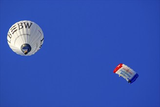 Landesbank BW hot air balloon and parachutist with open parachute in the air, as part of the