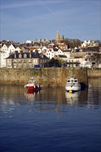 Boats in the harbour and the town of St Peter Port, Guernsey, Channel Islands, UK, Europe