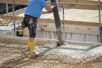 Construction site, concreting, the floor slab of a building is concreted, the concrete is pumped