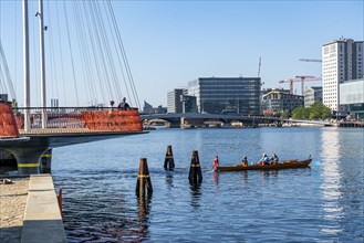 Cyclists on the Cirkelbroen cycle and pedestrian bridge, over the harbour, in the Christianshavens