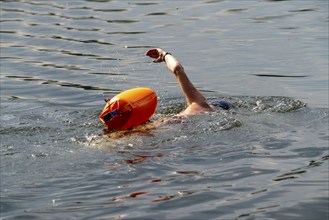 Open water swimmer, with marker buoy, in a lake, Wambachsee, 6-Seen-Platte, Duisburg, North