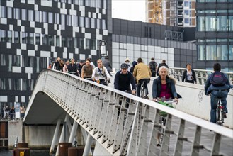 Cyclists on the Bryggebroen cycle and footpath bridge over the harbour, Sydhavnen, Copenhagen is