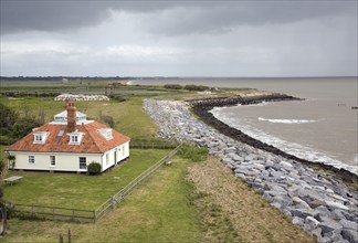 House at risk from coastal erosion, East Lane, Bawdsey, Suffolk, England, UK