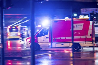 Ambulance on alarm, DRK, Essen fire brigade, rainy weather, city centre, evening, Essen, North