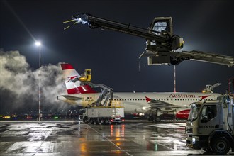 Winter at Frankfurt Main Airport, FRA, Austrian aircraft being de-iced by de-icing vehicles, Hesse,