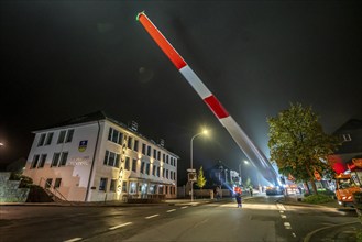 Transport of a 68 metre long, 22 tonne blade of a wind turbine, here in Breckerfeld, with a