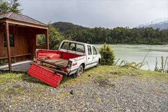 Wrack of a pickup at river Rio Baker upstream of village Caleta Tortel, road Carretera Austral,