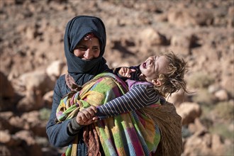 Berber woman, with baby on her back, traditional clothing, Morocco, Africa