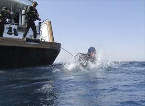 Diver jumping into the water from a dive boat, Red Sea, Egypt, Africa