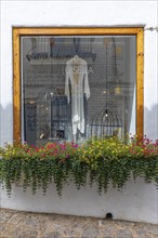 Window of a jewellery shop decorated with flowers in the old town of Eivissa, Ibiza Town, Ibiza,