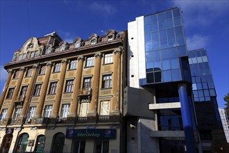 Houses, old building and modern building with glass facade, Romania, Banat, Timisoara, Timisoara,